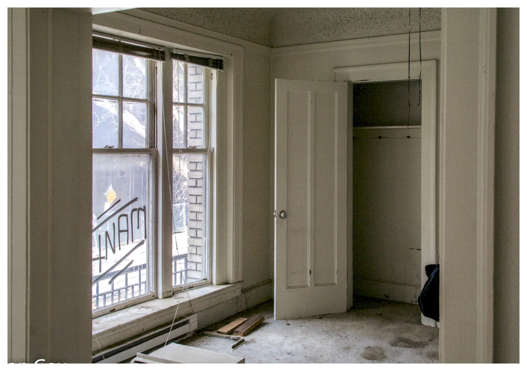 Before: view of unopened living area looking towards bay window prior to renovation.
